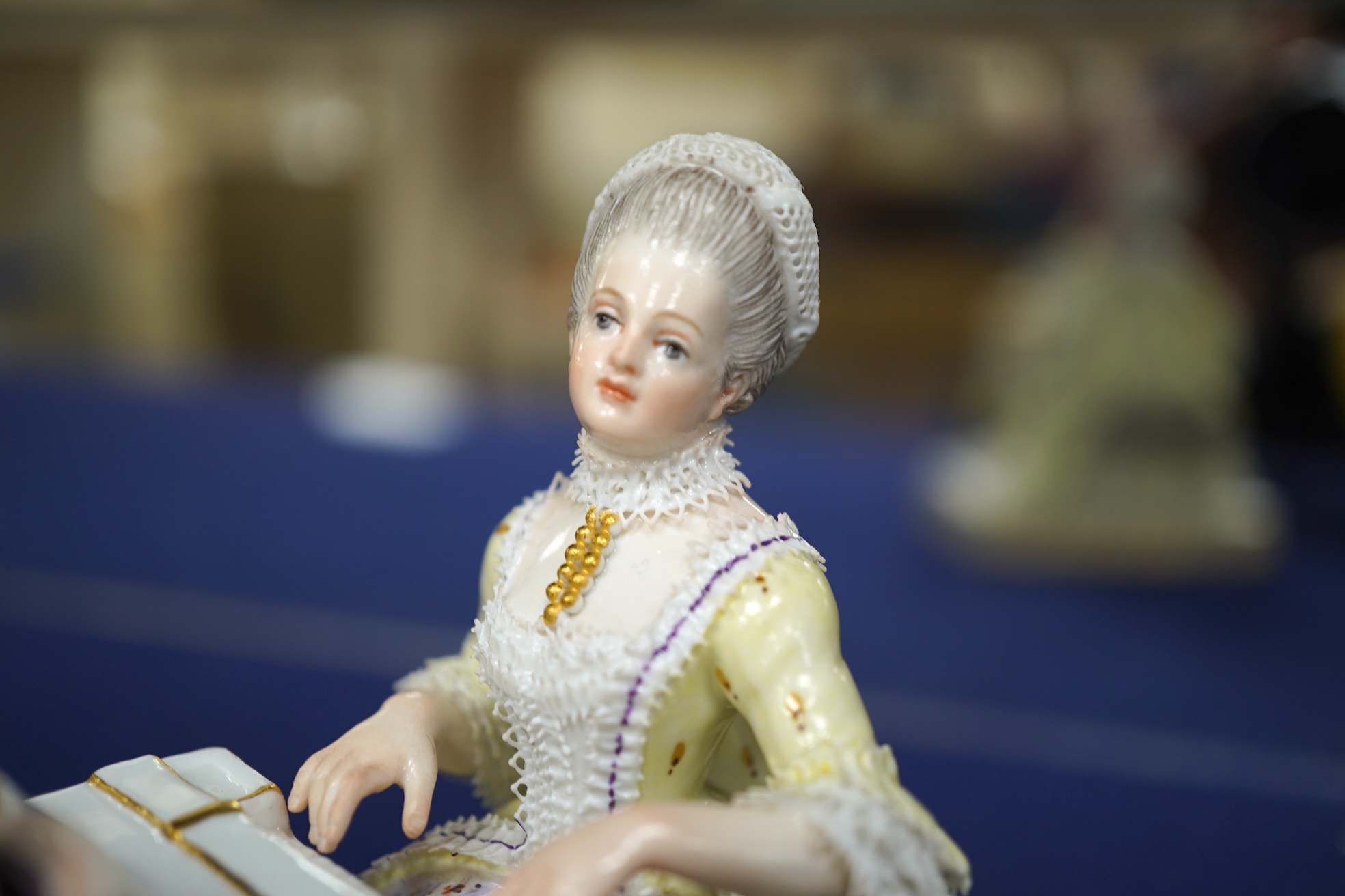 A pair of 19th century Meissen figures of a girl holding a shell and a boy holding a book, in size model number 628, tallest 13cm